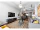 Open concept living room featuring a stylish rug, a TV, and dining area perfect for entertaining at 5455 Landmark Pl # 903, Greenwood Village, CO 80111