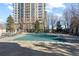 Outdoor pool and seating area for building residents beneath the shade of mature trees at 5455 Landmark Pl # 903, Greenwood Village, CO 80111