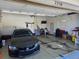 Spacious garage with an automatic door and black car parked inside at 7790 S Queensburg Way, Aurora, CO 80016