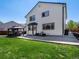 Spacious backyard with a lush green lawn, patio area, and covered gazebo at 13972 Hudson Way, Thornton, CO 80602