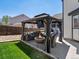 Backyard oasis with a covered gazebo, outdoor seating, and well-manicured lawn at 13972 Hudson Way, Thornton, CO 80602