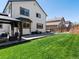 Spacious backyard with a lush lawn, patio area, and covered gazebo at 13972 Hudson Way, Thornton, CO 80602