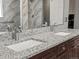 Granite counters highlight the dual sinks in this stylish and renovated bathroom at 13972 Hudson Way, Thornton, CO 80602