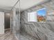 Modern bathroom featuring a spacious walk-in shower with gray stone and pebble floor at 13972 Hudson Way, Thornton, CO 80602