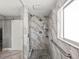 Modern bathroom featuring a spacious walk-in shower with gray stone at 13972 Hudson Way, Thornton, CO 80602