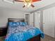 Comfortable bedroom with gray walls, ceiling fan and multiple door access at 13972 Hudson Way, Thornton, CO 80602
