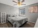 Cozy bedroom with gray walls, ceiling fan, large window, and carpeted floors at 13972 Hudson Way, Thornton, CO 80602