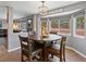 Cozy dining area with a round table, four chairs, and a bay window with natural light at 13972 Hudson Way, Thornton, CO 80602