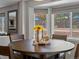 Inviting dining area featuring a round table with leather chairs and a large bay window at 13972 Hudson Way, Thornton, CO 80602