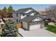 Aerial view of a two-story home featuring a brick facade, two car garage, and fenced in back yard at 13972 Hudson Way, Thornton, CO 80602