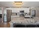 Spacious kitchen with white cabinets, granite countertops, stainless steel appliances, and a large island at 13972 Hudson Way, Thornton, CO 80602