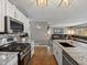 Modern kitchen featuring granite countertops, stainless steel appliances, and an island with a sink at 13972 Hudson Way, Thornton, CO 80602