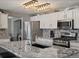 Modern kitchen with stainless steel appliances, granite countertops, and white cabinetry at 13972 Hudson Way, Thornton, CO 80602