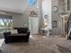 Spacious living room featuring a large window, high ceilings and neutral color palette at 13972 Hudson Way, Thornton, CO 80602