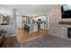 Open-concept floor plan with kitchen and living room featuring stone fireplace and dining area at 13972 Hudson Way, Thornton, CO 80602