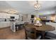 Open-concept living space featuring a kitchen, dining area, and living room with a fireplace at 13972 Hudson Way, Thornton, CO 80602
