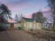 Charming single-story home with a green metal roof and cozy front porch, surrounded by trees at 1135 Orion St, Golden, CO 80401