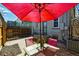 Backyard patio features a dining set under a red umbrella, creating a cozy outdoor space at 315 E Bayaud Ave, Denver, CO 80209