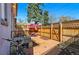 Charming backyard brick patio with table, chairs, fence and manicured yard at 315 E Bayaud Ave, Denver, CO 80209