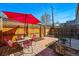 Inviting backyard brick patio with dining set shaded by a red umbrella at 315 E Bayaud Ave, Denver, CO 80209