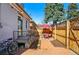 Charming backyard brick patio with table, chairs, manicured yard and fence at 315 E Bayaud Ave, Denver, CO 80209