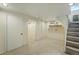Finished basement area with a staircase, clean carpet, and fresh paint at 315 E Bayaud Ave, Denver, CO 80209