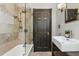Modern bathroom featuring a tub with shower, stone tile, and stylish vanity at 315 E Bayaud Ave, Denver, CO 80209