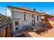 Gray painted home boasts back entrance, charming porch, and brick patio at 315 E Bayaud Ave, Denver, CO 80209
