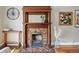 Ornate, decorative fireplace with brick and wood surround adds character and charm to the home at 315 E Bayaud Ave, Denver, CO 80209
