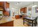 Well-lit kitchen featuring granite countertops, tile flooring, stainless steel appliances, and dark wood cabinetry at 315 E Bayaud Ave, Denver, CO 80209