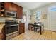 Cozy kitchen featuring stainless steel appliances, wooden cabinets, and a breakfast nook at 315 E Bayaud Ave, Denver, CO 80209