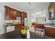 Kitchen with dark wood cabinets, stainless steel appliances, and granite countertops at 315 E Bayaud Ave, Denver, CO 80209