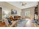 Inviting living room featuring hardwood floors, large windows, and a modern ceiling fan at 315 E Bayaud Ave, Denver, CO 80209