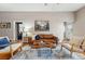 Comfortable living room featuring a brown leather couch, modern rug and bright, natural light at 315 E Bayaud Ave, Denver, CO 80209