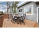 Back deck with outdoor dining furniture, offering ample space for relaxation and entertaining at 18997 E Crestridge Cir, Aurora, CO 80015