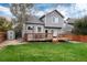 Spacious backyard with a well-maintained lawn, wooden deck, and storage shed at 18997 E Crestridge Cir, Aurora, CO 80015