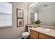 Well-lit bathroom with a vanity, modern mirror, and neutral décor at 18997 E Crestridge Cir, Aurora, CO 80015