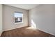 Cozy bedroom featuring neutral walls, plush carpet, and a sunny window at 18997 E Crestridge Cir, Aurora, CO 80015