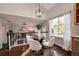 Cozy dining area with hardwood floors, a glass table, and a view of the living room and backyard at 18997 E Crestridge Cir, Aurora, CO 80015