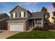 Charming two-story home with gray siding, attached garage, and manicured lawn at 18997 E Crestridge Cir, Aurora, CO 80015