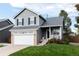 This two-story home features a well-manicured lawn and attached two-car garage at 18997 E Crestridge Cir, Aurora, CO 80015