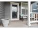 This house features a cozy front porch with seating, perfect for enjoying the outdoors at 18997 E Crestridge Cir, Aurora, CO 80015