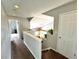 Hallway offering a glimpse into an open kitchen with modern fixtures and a plant shelf at 18997 E Crestridge Cir, Aurora, CO 80015