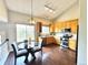 Eat-in kitchen with stainless steel appliances, wood cabinets, and modern lighting at 18997 E Crestridge Cir, Aurora, CO 80015
