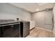 Well-equipped laundry room featuring modern washer and dryer units and ample storage at 18997 E Crestridge Cir, Aurora, CO 80015