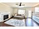 Inviting living room featuring a fireplace, hardwood floors, and large windows at 18997 E Crestridge Cir, Aurora, CO 80015