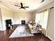 Cozy living room featuring a fireplace, hardwood floors, and ample natural light at 18997 E Crestridge Cir, Aurora, CO 80015