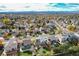This aerial view shows a neighborhood with tree-lined streets and well-maintained homes at 18997 E Crestridge Cir, Aurora, CO 80015