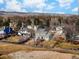 Scenic aerial view of houses in a neighborhood surrounded by mountains and trees at 4547 Tally Ho Trl, Boulder, CO 80301