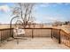 Inviting back deck overlooking open field, featuring a swing chair and wooden railing at 4547 Tally Ho Trl, Boulder, CO 80301